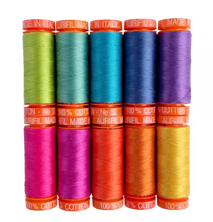 Aurifil Dragon’s Breath by Tula Pink 10-spool 50wt cotton thread collection with colorful spools and dragon artwork packaging
